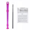 A pink 8-hole soprano recorder with a cleaning rod and a fingering chart.