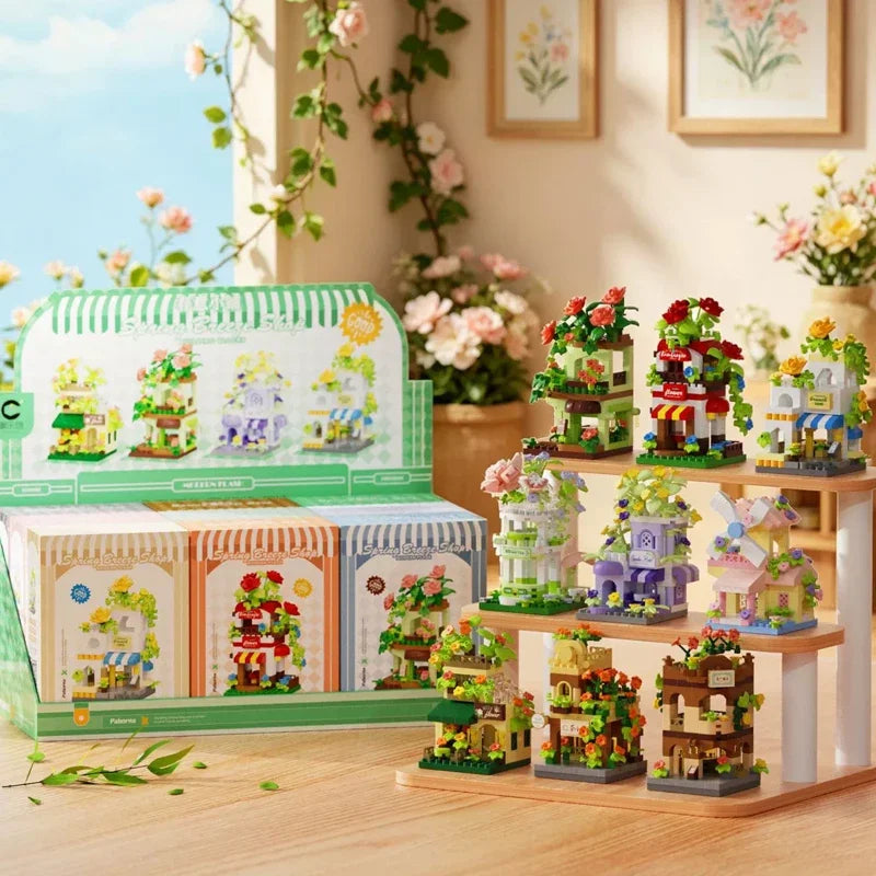 A collection of miniature wooden building sets featuring woodland and windmill themes displayed on a wooden shelf.