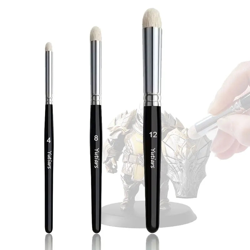 A set of 13 micro detail paint brushes in black and gold are shown next to a hand holding one brush.