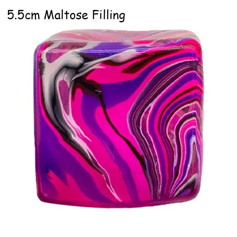 A vibrant, glossy cube toy with swirling pink, purple, and black marbled patterns.