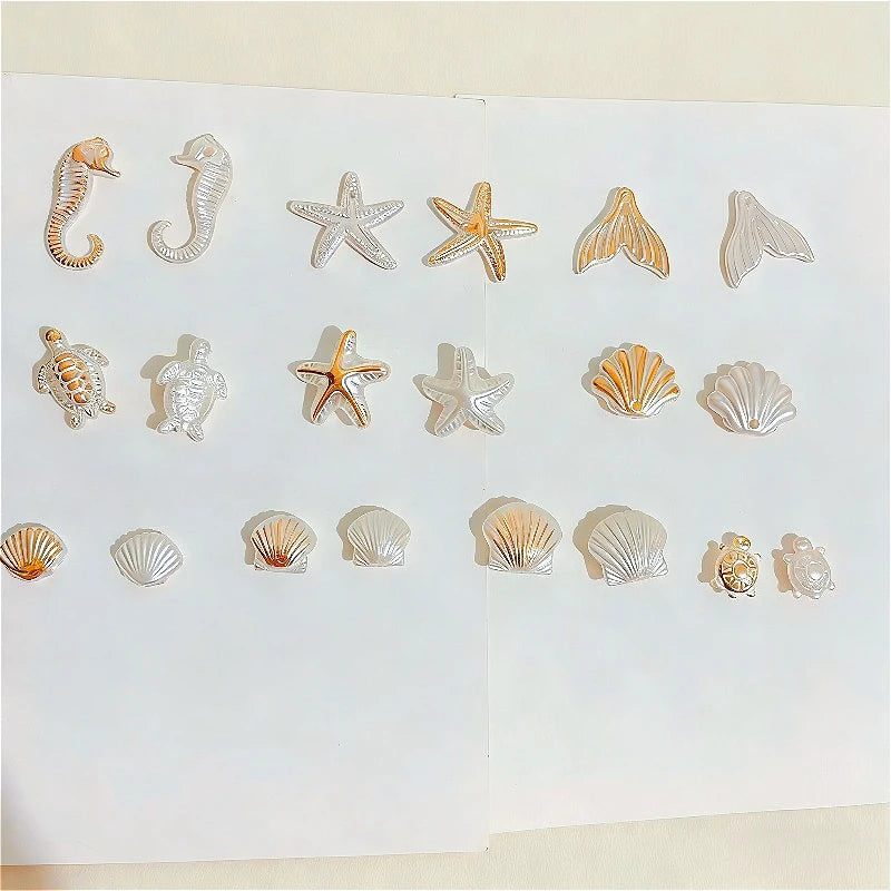 A collection of acrylic bead mixes shaped like various ocean animals including a seahorse, starfish, and seashells.
