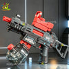 A black and red automatic electric UMP45 water blaster rifle is displayed on a reflective surface.