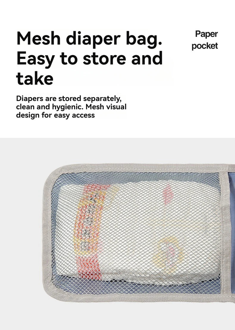 A mesh diaper bag with a paper pocket showing a light gray and white changing mat.