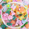 A bowl filled with assorted colorful candy resin flatbacks for DIY crafts and jewelry making
