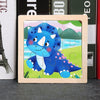 A wooden jigsaw puzzle featuring a blue dinosaur in a green landscape with blue water.