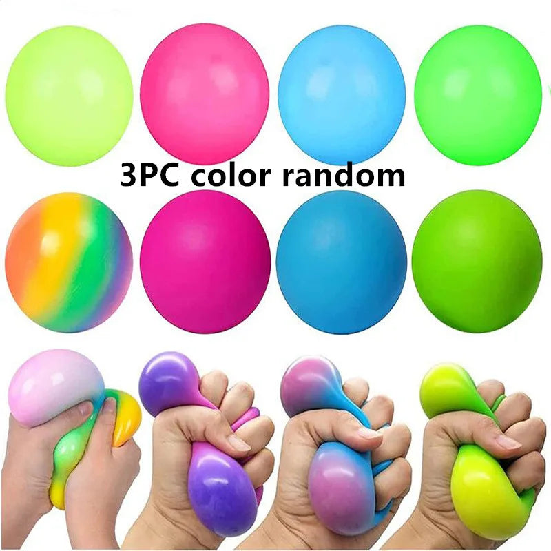 A collection of nine stress relief balls in various colors including lime green, pink, blue, and yellow, shown being held by 