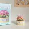 A miniature flower bouquet building block set featuring pink and green flowers and a butterfly detail.