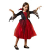 A young girl wearing a red and black vampire bat costume set with a cape and accessories.