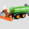 A green remote control tractor with a trailer and lights is shown on a gray background.