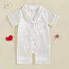A white satin button-up romper sleepwear for toddlers with a collar and chest pocket.