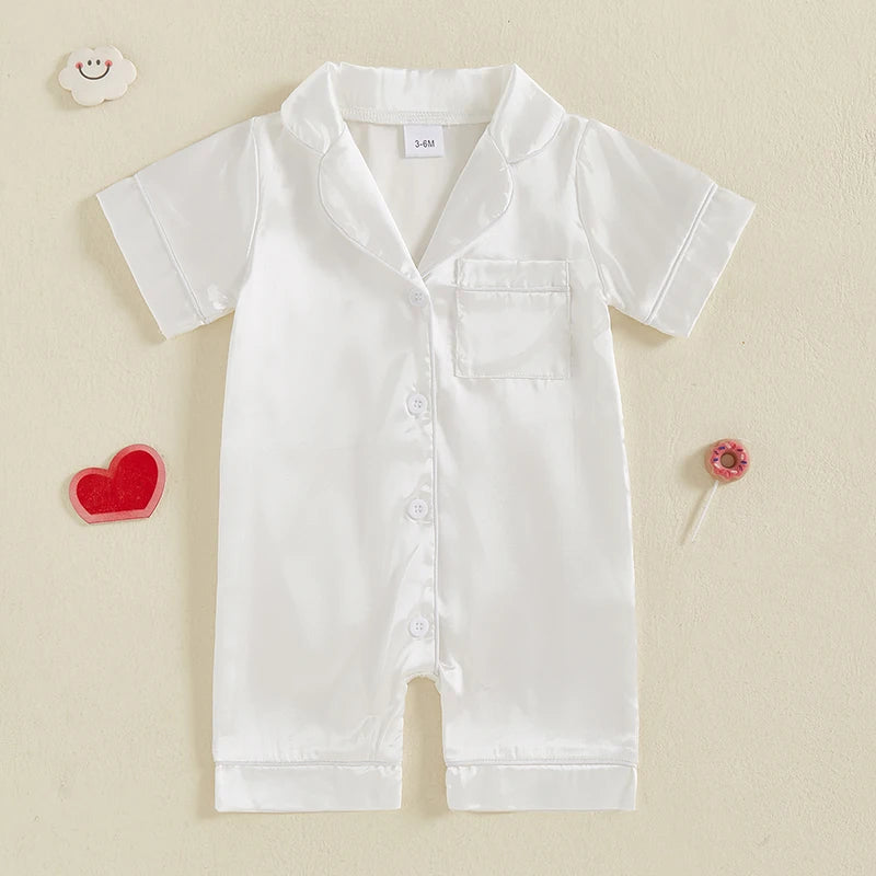 A white satin button-up romper sleepwear for toddlers with a collar and chest pocket.