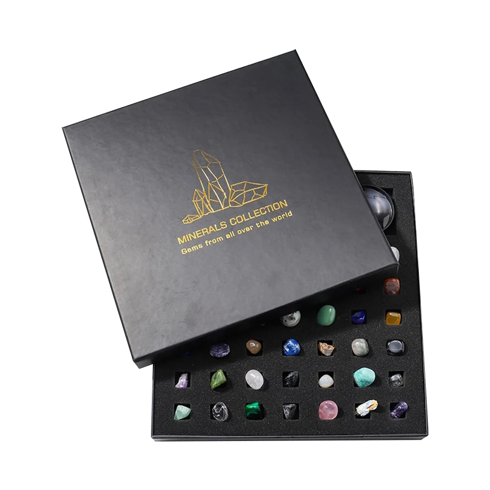 A black gift box containing a collection of various natural crystals and minerals.
