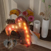 A heart-shaped silicone mold glows with internal lights, casting a warm, colorful resin design.