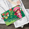 A green card featuring a cute pink strawberry and shortcake character surrounded by fruit and foliage on banknotes.