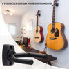 A wall mount guitar hanger displaying two acoustic guitars on a dark wooden shelf.