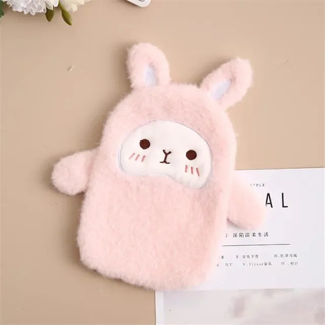 A pink plush-covered hot water bottle shaped like a cute animal with long ears and a round face.