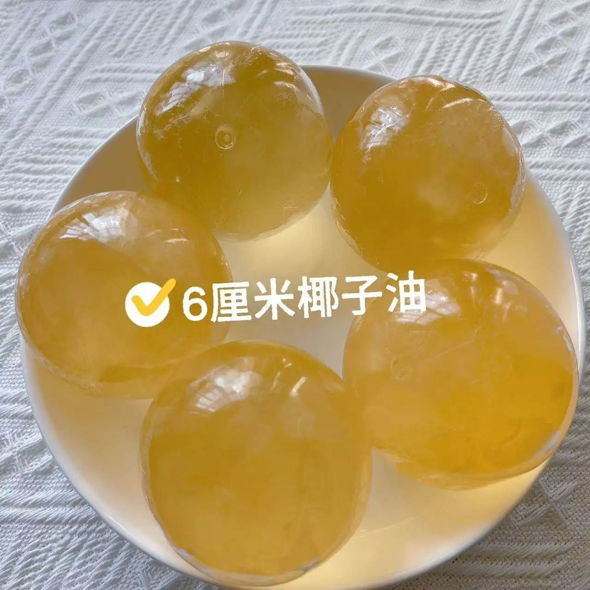 Six-centimeter yellow squeeze balls made from coconut oil for stress relief.