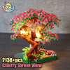 A detailed building block set depicting a cherry tree view with illuminated pink blossoms and a wooden structure.