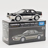 A black Toyota Sprinter Trueno model car in a box, featuring a scale 1:64 die-cast collectible.