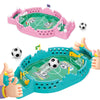 A pink tabletop foosball game set with a ball and goal, being held by hands.