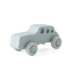 A light gray silicone baby teether toy shaped like a cartoon car with round wheels.