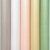 A vertical stack of twenty translucent tissue paper sheets in soft pastel shades including beige, pink, yellow, and light gre