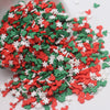 A pile of small, colorful cartoon polymer clay slices in red, green, and white for slime and craft projects.