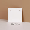 A white square jewelry display card is shown against a beige background, with dimensions listed as 50p 7x7cm.