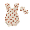 A beige romper set for a baby girl with matching ruffled fabric and a bow headband