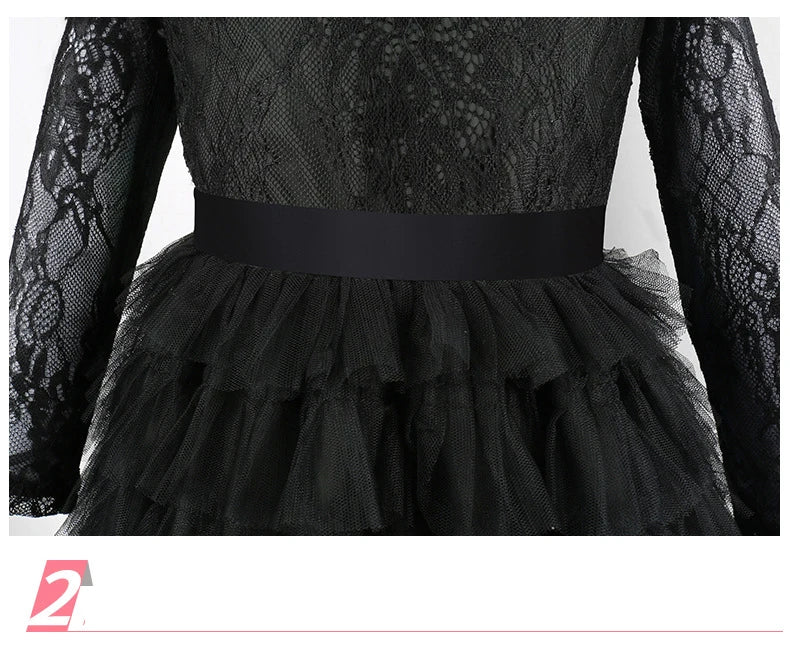Black lace long-sleeved dress with a ruffled skirt and a black sash for a kids' witch costume.