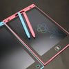 A pink and blue LCD writing tablet with two pens is shown on a dark surface.