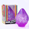 A purple squishy toy shaped like a raindrop is shown in its packaging.
