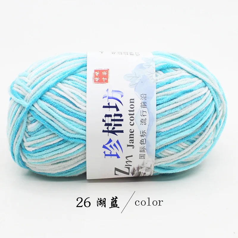 A ball of light blue and white yarn labeled Zim Jane cotton yarn for knitting and crochet