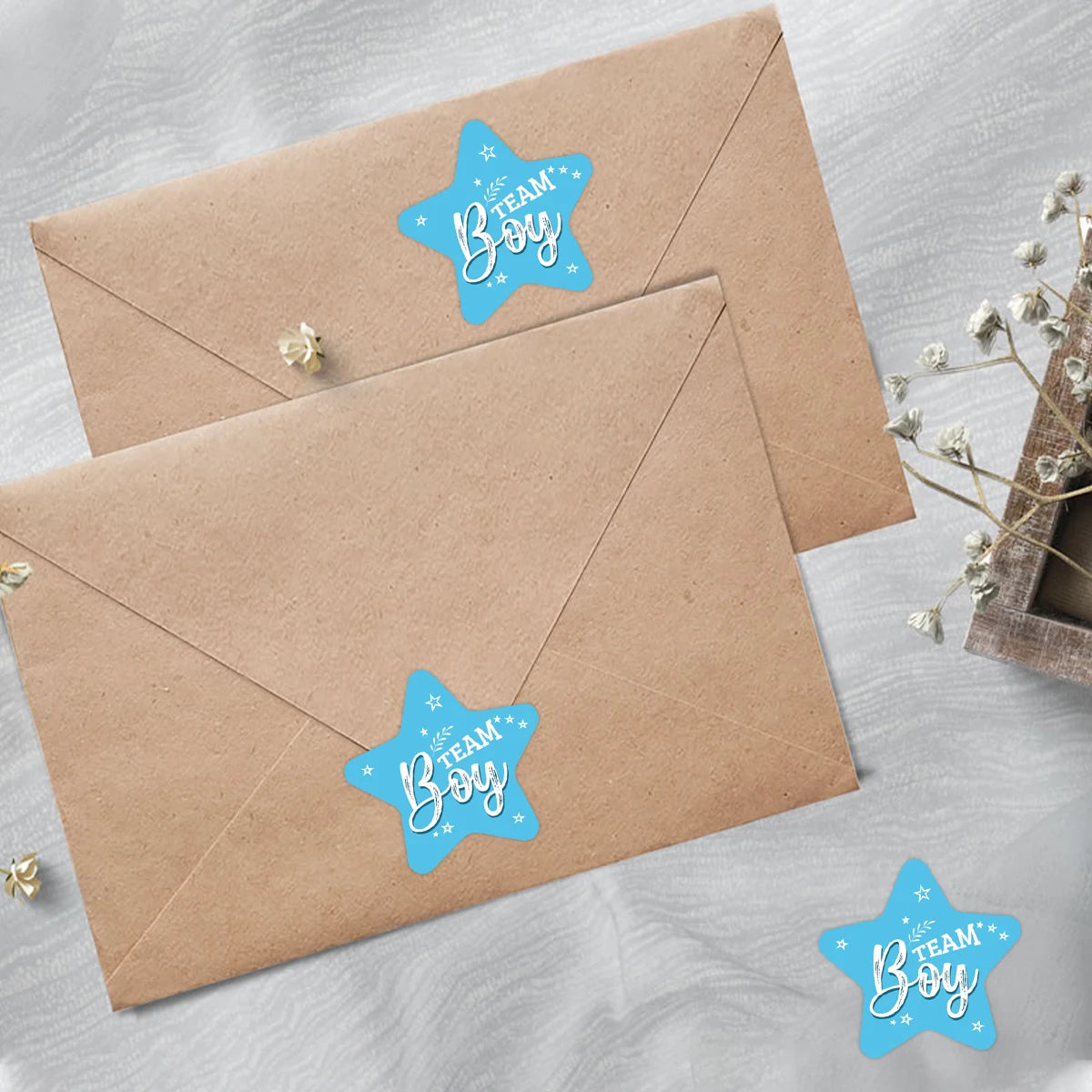 A brown envelope featuring a light blue star design with the text Boy team for baby shower stickers