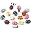 A collection of polished, oval glass coffee bean beads in various colors and shades for jewelry making.
