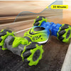 A bright green and blue remote control stunt car is shown driving on an asphalt track.