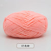 A ball of light pink pre-dyed milk cotton yarn used for knitting and crochet.