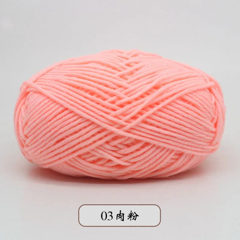 A ball of light pink pre-dyed milk cotton yarn used for knitting and crochet.