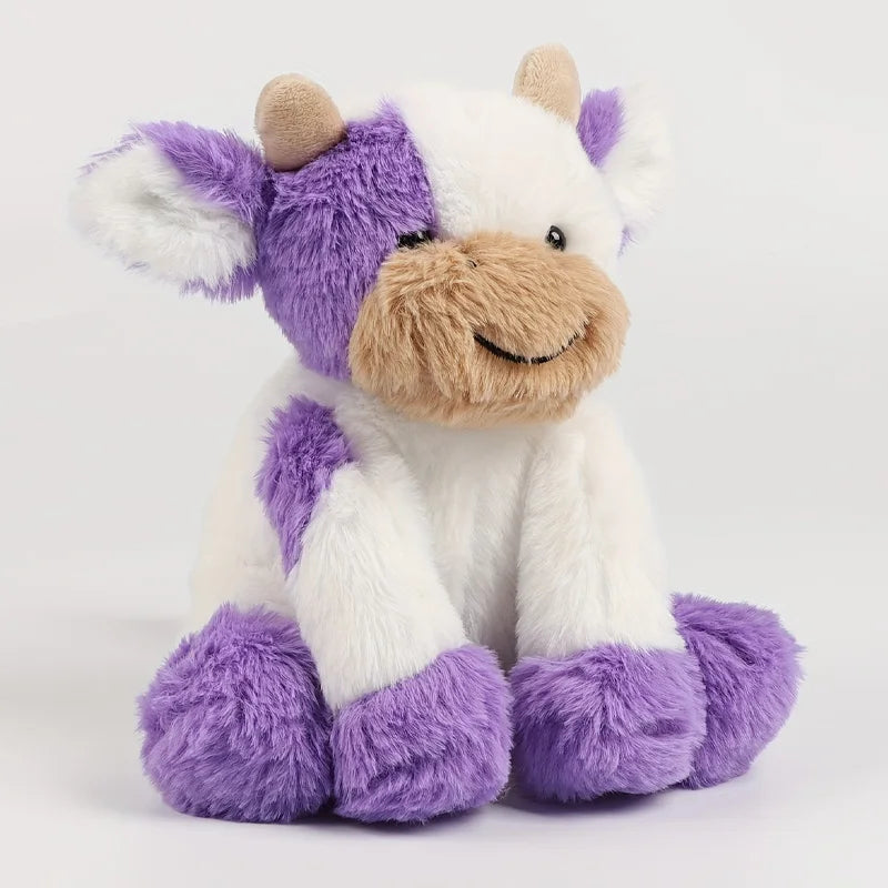 A white and purple plush toy of a cow with light brown accents sitting down.