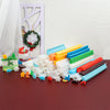 A collection of 50 silicone soap and candle molds in various colors and shapes laid out on a dark surface.