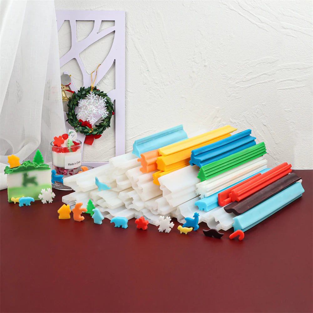 A collection of 50 silicone soap and candle molds in various colors and shapes laid out on a dark surface.