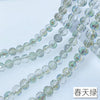 A close-up of a strand of clear, iridescent Austrian crystal beads with AB coating.