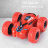 A red mini inertia car toy with large tires is shown on a white surface.