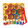 A wooden hexagonal game featuring bee-shaped clips and various colored beads for fine motor skill development.