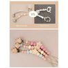 Comparison showing a safe and durable star wood baby pacifier clip versus an easy to break version.