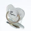 A clear silicone baby pacifier with a crown design and the name Angelica engraved in rhinestone lettering.