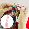 Hands are using an ergonomic yarn guide ring to assist in crochet or knitting.