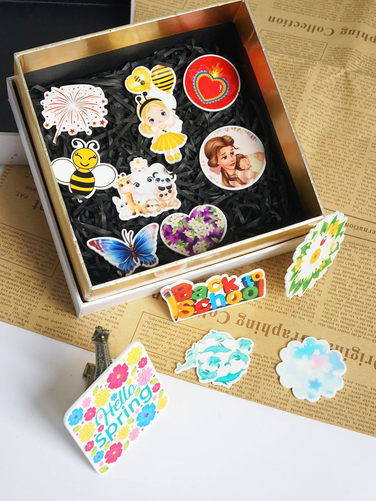 A gold-edged box filled with ten autumn pumpkin flatback resin décor items including bees, flowers, and leaves.