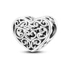 A sterling silver heart-shaped charm bead with intricate scrollwork design.