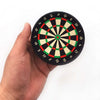 A hand holds a mini EVA foam dart holder target board with concentric rings and numbered segments.